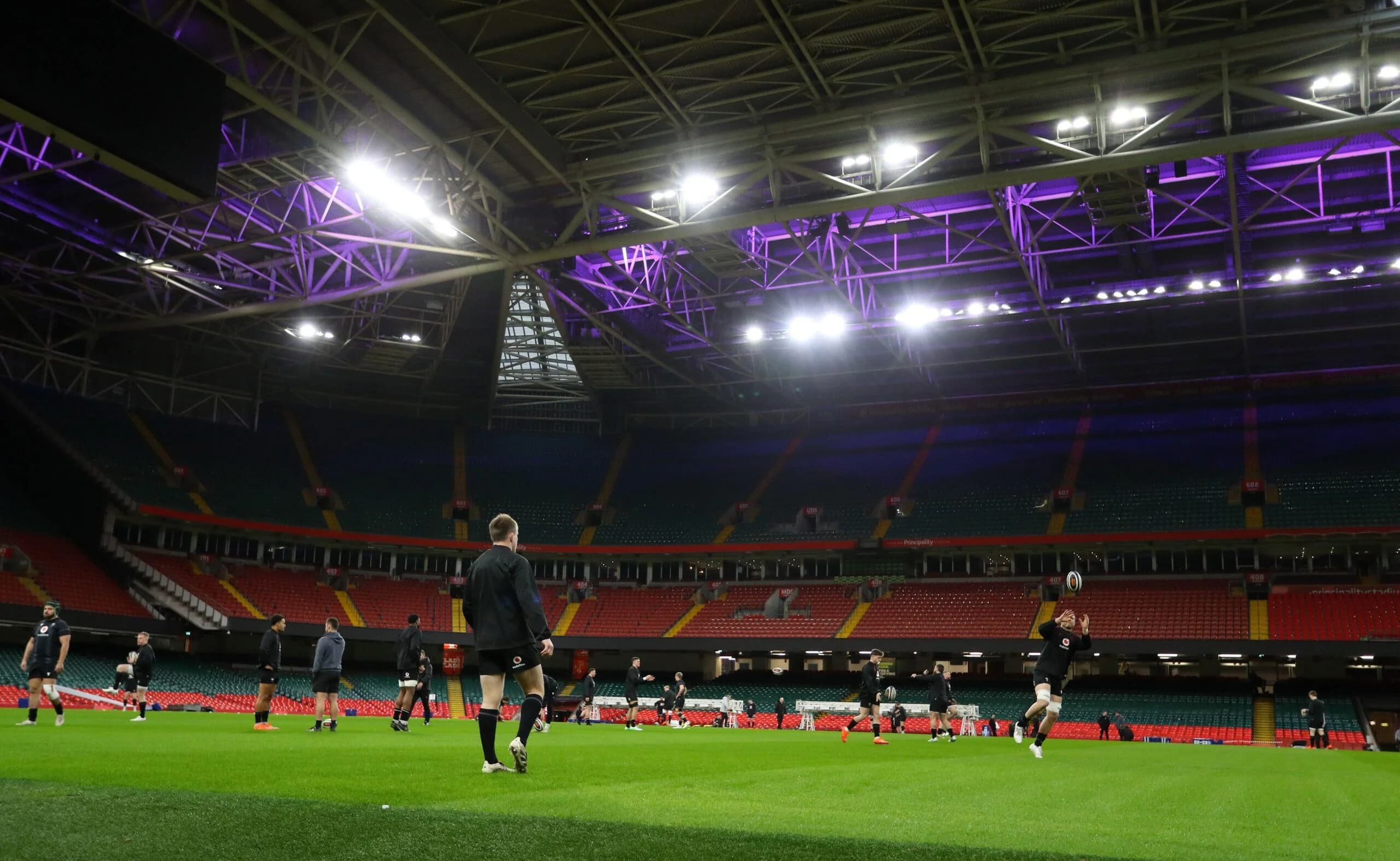 Wales players train under the closed roof of the Principality stadium.