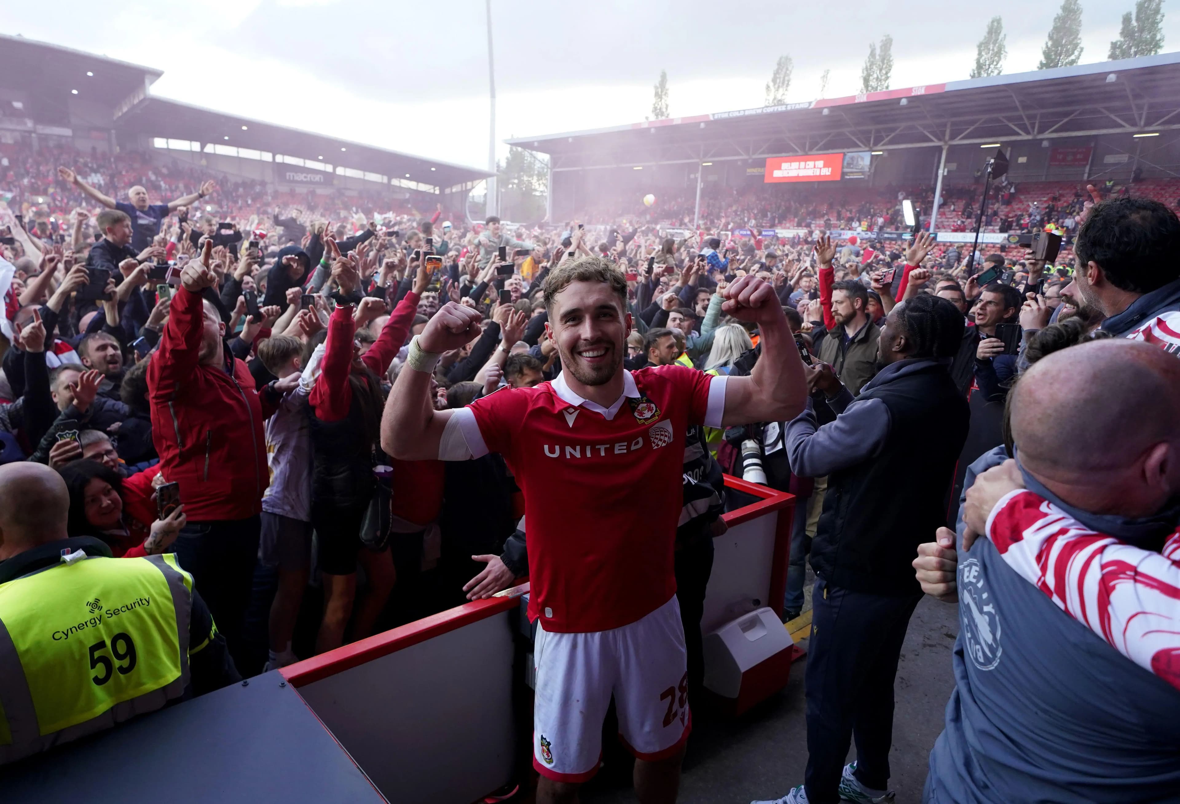 Wrexham's Sam Smith joins fans in celebrating promotion. Pic: Alamy